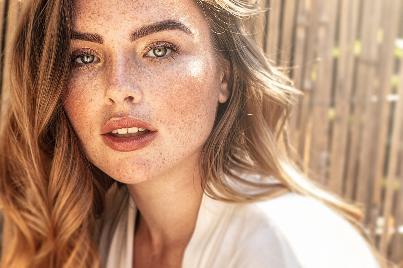 Portrait of young redhead woman with freckles.